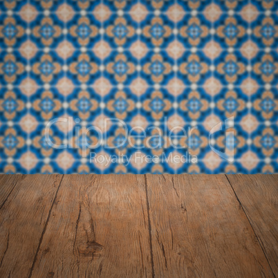 Wood table top and blur vintage ceramic tile pattern wall