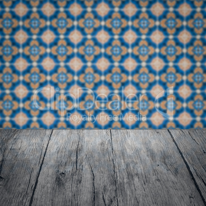 Wood table top and blur vintage ceramic tile pattern wall