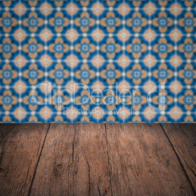 Wood table top and blur vintage ceramic tile pattern wall