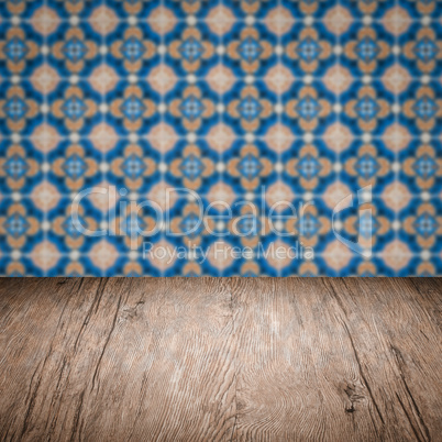 Wood table top and blur vintage ceramic tile pattern wall