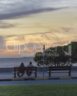 Couple Enjoying at Sunset Scene at Boardwalk in Montevideo