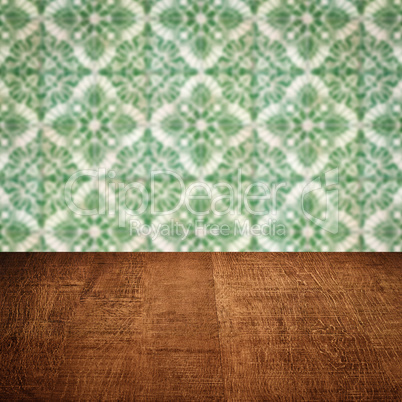 Wood table top and blur vintage ceramic tile pattern wall Wood table top and blur vintage ceramic tile pattern wall