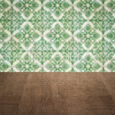 Wood table top and blur vintage ceramic tile pattern wall