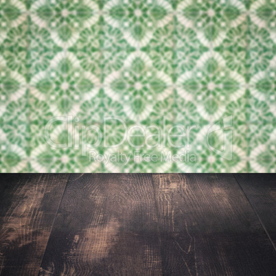 Wood table top and blur vintage ceramic tile pattern wall