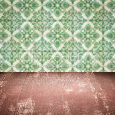 Wood table top and blur vintage ceramic tile pattern wall