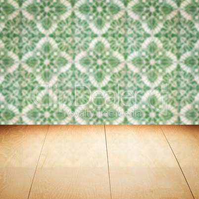 Wood table top and blur vintage ceramic tile pattern wall