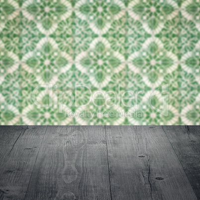 Wood table top and blur vintage ceramic tile pattern wall