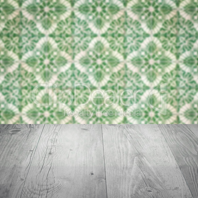 Wood table top and blur vintage ceramic tile pattern wall