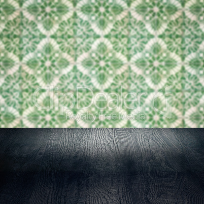 Wood table top and blur vintage ceramic tile pattern wall Wood table top and blur vintage ceramic tile pattern wall