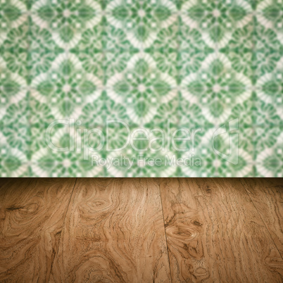 Wood table top and blur vintage ceramic tile pattern wall