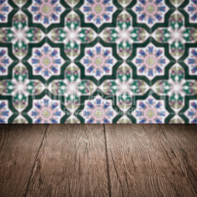 Wood table top and blur vintage ceramic tile pattern wall