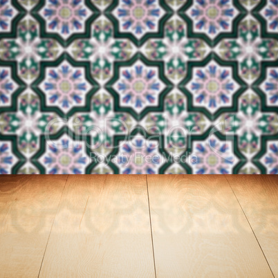 Wood table top and blur vintage ceramic tile pattern wall