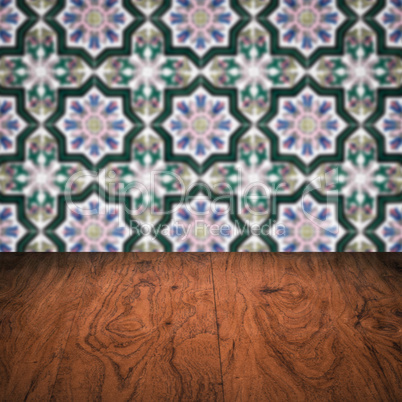 Wood table top and blur vintage ceramic tile pattern wall