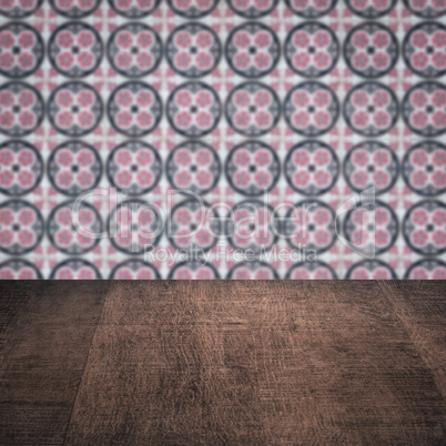 Wood table top and blur vintage ceramic tile pattern wall Wood table top and blur vintage ceramic tile pattern wall