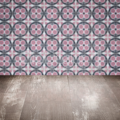 Wood table top and blur vintage ceramic tile pattern wall