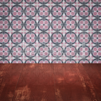 Wood table top and blur vintage ceramic tile pattern wall