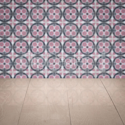 Wood table top and blur vintage ceramic tile pattern wall Wood table top and blur vintage ceramic tile pattern wall
