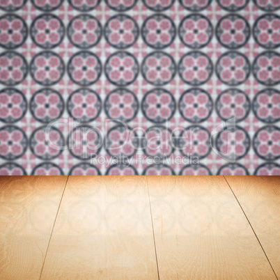 Wood table top and blur vintage ceramic tile pattern wall Wood table top and blur vintage ceramic tile pattern wall