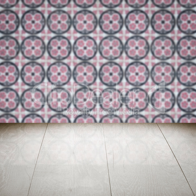 Wood table top and blur vintage ceramic tile pattern wall Wood table top and blur vintage ceramic tile pattern wall