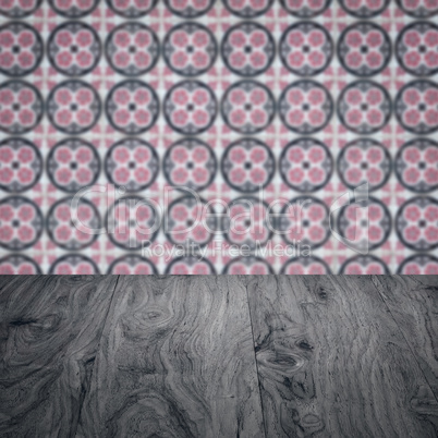 Wood table top and blur vintage ceramic tile pattern wall Wood table top and blur vintage ceramic tile pattern wall