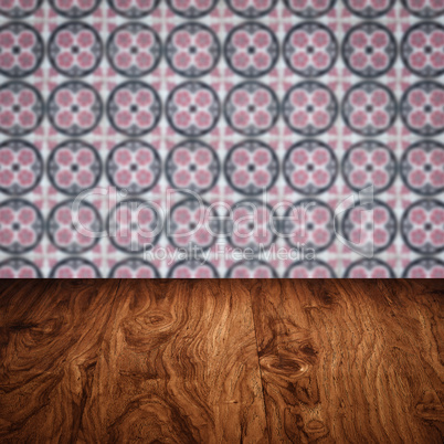 Wood table top and blur vintage ceramic tile pattern wall