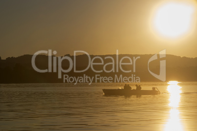 Motor boat, sunset at the lake