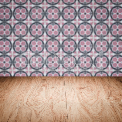 Wood table top and blur vintage ceramic tile pattern wall