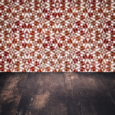 Wood table top and blur vintage ceramic tile pattern wall Wood table top and blur vintage ceramic tile pattern wall