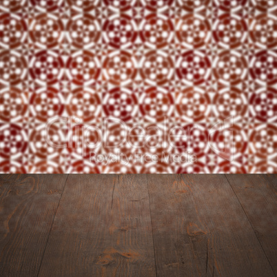 Wood table top and blur vintage ceramic tile pattern wall