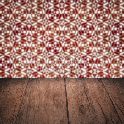 Wood table top and blur vintage ceramic tile pattern wall