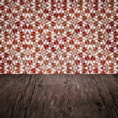 Wood table top and blur vintage ceramic tile pattern wall