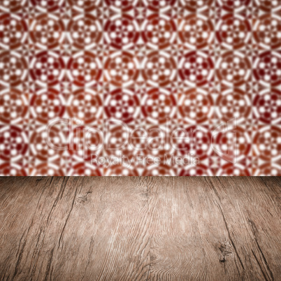 Wood table top and blur vintage ceramic tile pattern wall