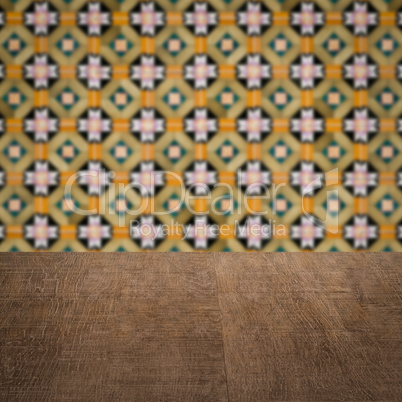 Wood table top and blur vintage ceramic tile pattern wall