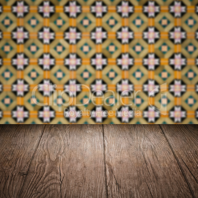 Wood table top and blur vintage ceramic tile pattern wall