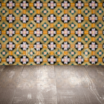 Wood table top and blur vintage ceramic tile pattern wall