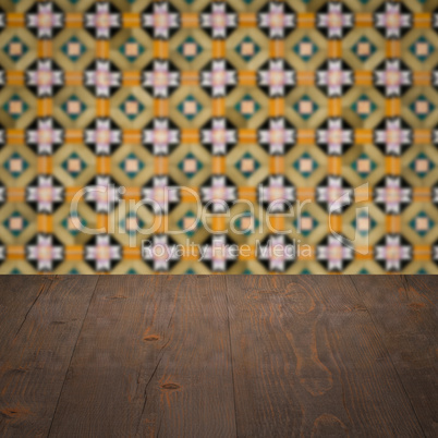 Wood table top and blur vintage ceramic tile pattern wall