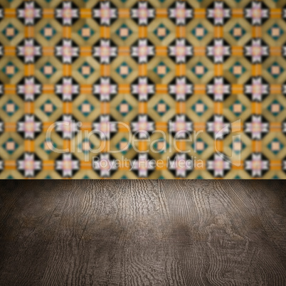 Wood table top and blur vintage ceramic tile pattern wall