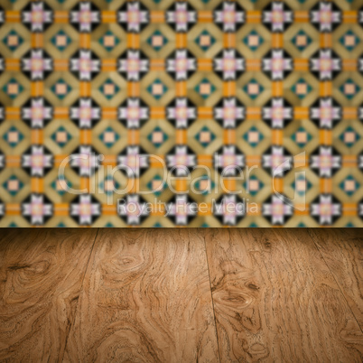 Wood table top and blur vintage ceramic tile pattern wall