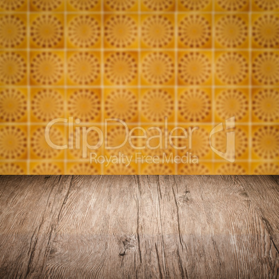 Wood table top and blur vintage ceramic tile pattern wall