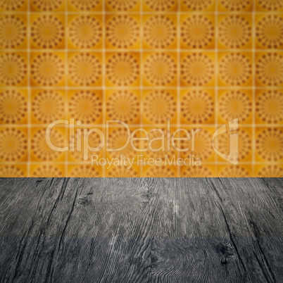 Wood table top and blur vintage ceramic tile pattern wall