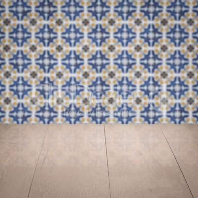 Wood table top and blur vintage ceramic tile pattern wall Wood table top and blur vintage ceramic tile pattern wall