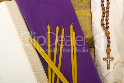 Thin candles on purple cloth used in religion