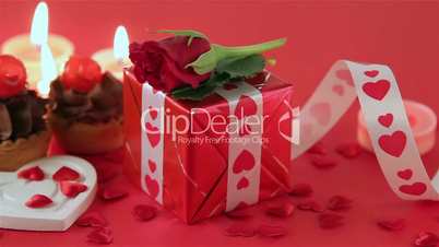 Chocolate cupcake with roses and gift at candlelight