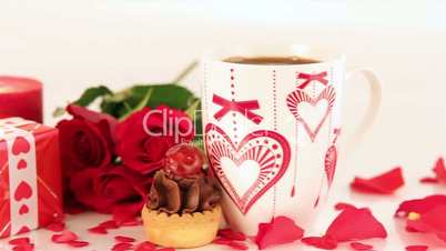 Chocolate cupcake and coffee with roses and gift