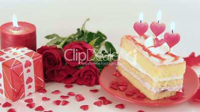 Decorated cake with candles and roses for Valentine's Day