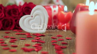 Red roses and heart shape on wooden background