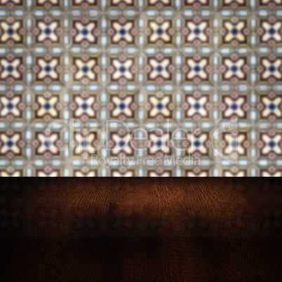 Wood table top and blur vintage ceramic tile pattern wall