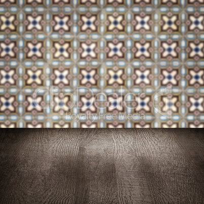 Wood table top and blur vintage ceramic tile pattern wall