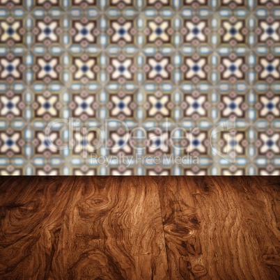 Wood table top and blur vintage ceramic tile pattern wall