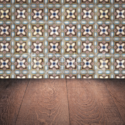 Wood table top and blur vintage ceramic tile pattern wall